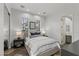 Well-lit bedroom with neutral tones, dual windows, closet and adjacent bathroom at 2822 Soft Horizon Way, Las Vegas, NV 89135