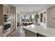 Bright dining area with modern light fixture, stylish furniture, and large windows at 2822 Soft Horizon Way, Las Vegas, NV 89135