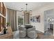Stylish dining area featuring a round table, contemporary lighting, and a glimpse of the modern kitchen at 2822 Soft Horizon Way, Las Vegas, NV 89135