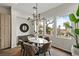 Cozy dining space with round table, modern chandelier, stylish decor, and natural light from large windows at 2822 Soft Horizon Way, Las Vegas, NV 89135