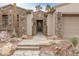 Inviting home entrance with a stone pathway, manicured bushes, and decorative stone accents at 2822 Soft Horizon Way, Las Vegas, NV 89135