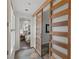 Hallway showcases unique tile flooring, leading to a bedroom with sliding barn doors at 2822 Soft Horizon Way, Las Vegas, NV 89135