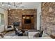 Cozy living area with a stone accent wall, built-in shelving, fireplace, and backyard view at 2822 Soft Horizon Way, Las Vegas, NV 89135