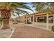 Backyard with low-maintenance gravel landscaping, covered patio, and palm trees, creating a serene outdoor space at 3020 Ripon Dr, Las Vegas, NV 89134