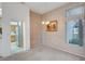 Dining area with neutral carpet, a modern chandelier, and a view to the kitchen at 3020 Ripon Dr, Las Vegas, NV 89134