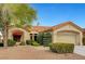 Inviting single-story home featuring a lush landscaped front yard, red awning, and tile roof at 3020 Ripon Dr, Las Vegas, NV 89134