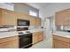Kitchen showcasing white tile countertops and light wood cabinetry at 3020 Ripon Dr, Las Vegas, NV 89134