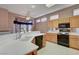 Well-lit kitchen with light wood cabinets, white tile countertops and black appliances at 3020 Ripon Dr, Las Vegas, NV 89134