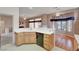 Kitchen featuring wood cabinets, tile countertops, and black appliances at 3020 Ripon Dr, Las Vegas, NV 89134