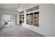 Bright living room featuring neutral carpet, fan, and sliding glass door to backyard at 3020 Ripon Dr, Las Vegas, NV 89134