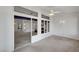 Bright, carpeted living room with adjacent room viewed through window feature at 3020 Ripon Dr, Las Vegas, NV 89134