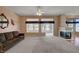 Bright living room with plush carpet, fireplace, and large windows providing natural light at 3020 Ripon Dr, Las Vegas, NV 89134