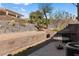 The backyard features several levels of desert landscaping, a grill and table at 3362 Pheasant Canyon Way # 1005, Laughlin, NV 89029