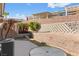 The backyard has low retaining walls with desert landscaping and a covered patio at 3362 Pheasant Canyon Way # 1005, Laughlin, NV 89029
