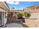 Low retaining walls define the backyard space, which features native landscaping and a covered patio at 3362 Pheasant Canyon Way # 1005, Laughlin, NV 89029