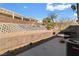 A view of the backyard, including landscaping, a grill, and an air conditioning unit at 3362 Pheasant Canyon Way # 1005, Laughlin, NV 89029