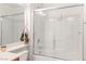 Modern bathroom featuring a shower-tub, bright lighting, and a clear glass door at 3362 Pheasant Canyon Way # 1005, Laughlin, NV 89029