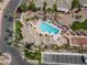 Aerial view of a community pool with lounge seating, landscaping, nearby parking, and residential homes at 3362 Pheasant Canyon Way # 1005, Laughlin, NV 89029
