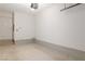 Functional garage featuring a clean floor, painted walls, access door, and overhead lighting for convenience at 3362 Pheasant Canyon Way # 1005, Laughlin, NV 89029