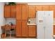 Charming kitchen with wooden cabinets, a built-in desk area, and a modern refrigerator perfect for Gathering living at 3362 Pheasant Canyon Way # 1005, Laughlin, NV 89029