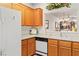Bright kitchen featuring wood cabinets, white countertops, a sink and dishwasher for easy cleanup at 3362 Pheasant Canyon Way # 1005, Laughlin, NV 89029