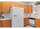 Well-lit kitchen with a large refrigerator, ample wooden cabinets, and a clean white countertop with an adjacent sink at 3362 Pheasant Canyon Way # 1005, Laughlin, NV 89029