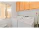 Laundry room with a window, built-in cabinets and shelving, and white washer and dryer units at 3362 Pheasant Canyon Way # 1005, Laughlin, NV 89029