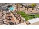 Aerial view of community putting green and pool amenity with neighboring residential homes and landscaping at 3362 Pheasant Canyon Way # 1005, Laughlin, NV 89029