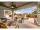 Charming backyard with pool, comfortable patio seating, and lush landscaping, perfect for entertaining at 3920 Eiderdown Pl, North Las Vegas, NV 89084