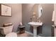 Charming powder room with pedestal sink and decorative accents at 3920 Eiderdown Pl, North Las Vegas, NV 89084