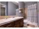 Bathroom featuring tile floors, dark wood cabinets and shower/tub with curtain at 3920 Eiderdown Pl, North Las Vegas, NV 89084