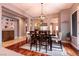 Elegant dining room with wood floors, a modern chandelier, and an open layout to other living spaces at 3920 Eiderdown Pl, North Las Vegas, NV 89084