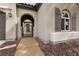 Charming front entrance featuring a gated courtyard and arched entryway, enhancing curb appeal at 3920 Eiderdown Pl, North Las Vegas, NV 89084