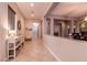 Long hallway with tile flooring and decorative accents, leading to multiple rooms within the house at 3920 Eiderdown Pl, North Las Vegas, NV 89084
