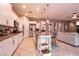 Modern kitchen with white cabinets, granite countertops, stainless steel appliances, and an island with barstool seating at 3920 Eiderdown Pl, North Las Vegas, NV 89084