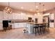 Bright kitchen features white cabinets, a large island with barstool seating, stainless steel appliances, and granite counters at 3920 Eiderdown Pl, North Las Vegas, NV 89084