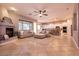 Open-concept living room with fireplace and view of the kitchen, complete with tile flooring and natural light at 3920 Eiderdown Pl, North Las Vegas, NV 89084
