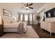 Stylish bedroom with a ceiling fan, modern decor, and a large window letting in plenty of natural light at 3920 Eiderdown Pl, North Las Vegas, NV 89084