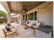 Inviting covered patio with stylish seating, ceiling fan, and ambient string lights, perfect for outdoor relaxation at 3920 Eiderdown Pl, North Las Vegas, NV 89084