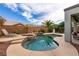 Beautiful pool with attached spa, waterfall feature, and lush tropical landscaping offers a private backyard oasis at 3920 Eiderdown Pl, North Las Vegas, NV 89084