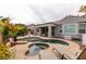 Backyard featuring a sparkling pool, jacuzzi, and lounge chairs for relaxing, surrounded by mature landscaping at 3920 Eiderdown Pl, North Las Vegas, NV 89084