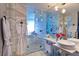 Luxurious bathroom features marble tile, double sinks, glass-enclosed shower, and plush white robes at 4381 W Flamingo Rd # 2605, Las Vegas, NV 89103