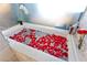 Tranquil tub filled with rose petals, accompanied by champagne and fresh flowers at 4381 W Flamingo Rd # 2605, Las Vegas, NV 89103
