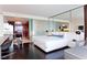 Modern bedroom boasts dark wood floors, comfortable bed, mirrored walls and partially open kitchen at 4381 W Flamingo Rd # 2605, Las Vegas, NV 89103