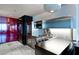 Modern kitchen area featuring stainless steel appliances, countertop seating, and shiny red closet doors at 4381 W Flamingo Rd # 2605, Las Vegas, NV 89103