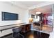 Inviting living area with sleek black desk and a TV, with a view to the convenient stainless steel kitchen at 4381 W Flamingo Rd # 2605, Las Vegas, NV 89103