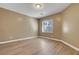 This cozy bedroom features a window for natural light, and wood-look flooring at 4685 Apulia Dr # 202, North Las Vegas, NV 89084
