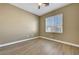 This cozy bedroom features a ceiling fan, natural light, and wood-look flooring at 4685 Apulia Dr # 202, North Las Vegas, NV 89084