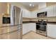Bright kitchen with stainless steel appliances, white cabinets, and tile flooring at 4685 Apulia Dr # 202, North Las Vegas, NV 89084