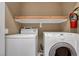 Laundry area complete with washer, dryer and shelving above at 4685 Apulia Dr # 202, North Las Vegas, NV 89084